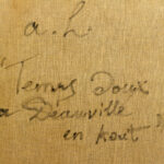 Detailed view of the artist's inscription on the back of André Hambourg's 'Temps Doux à Deauville en Août,' handwritten in black ink on canvas.