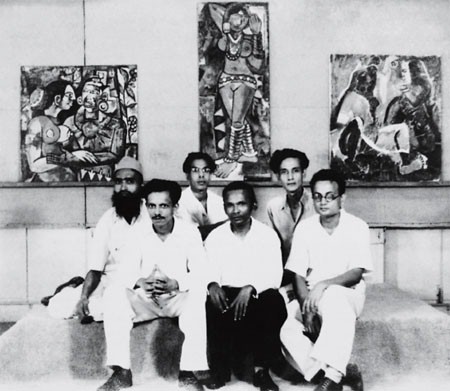 Members of the Bombay Progressive Artists' Group, including Sayed Haider Raza, K. H. Ara, and F. N. Souza, posing in front of their artworks, representing the innovative spirit of the group in 1947.