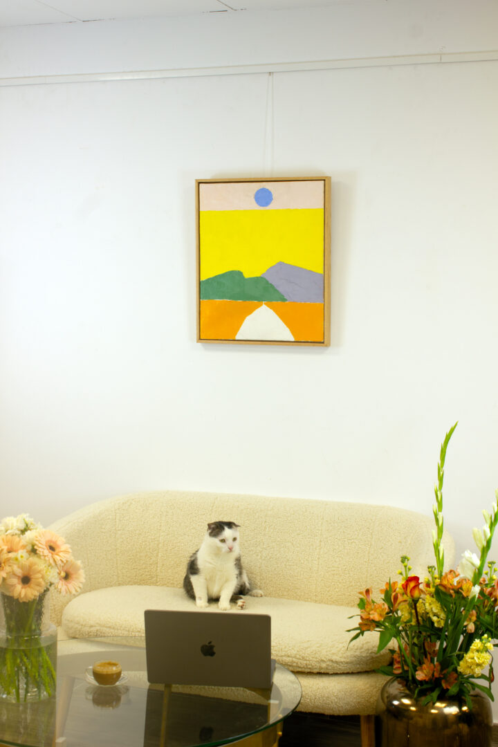 The painting "Pathway to the Sun" hanging on a white wall above a modern sofa, presenting a contemporary living space setting.