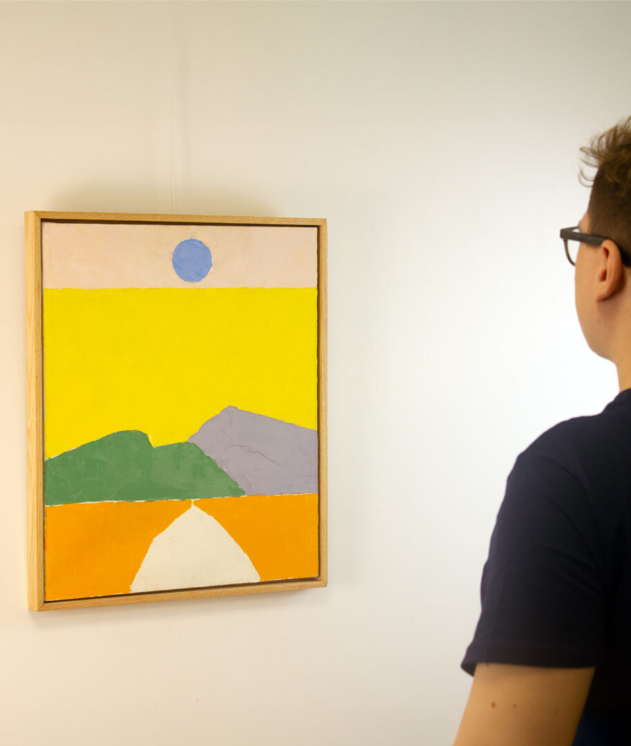 A viewer admiring Etel Adnan’s "Pathway to the Sun," highlighting the painting’s vibrant colors and bold composition.