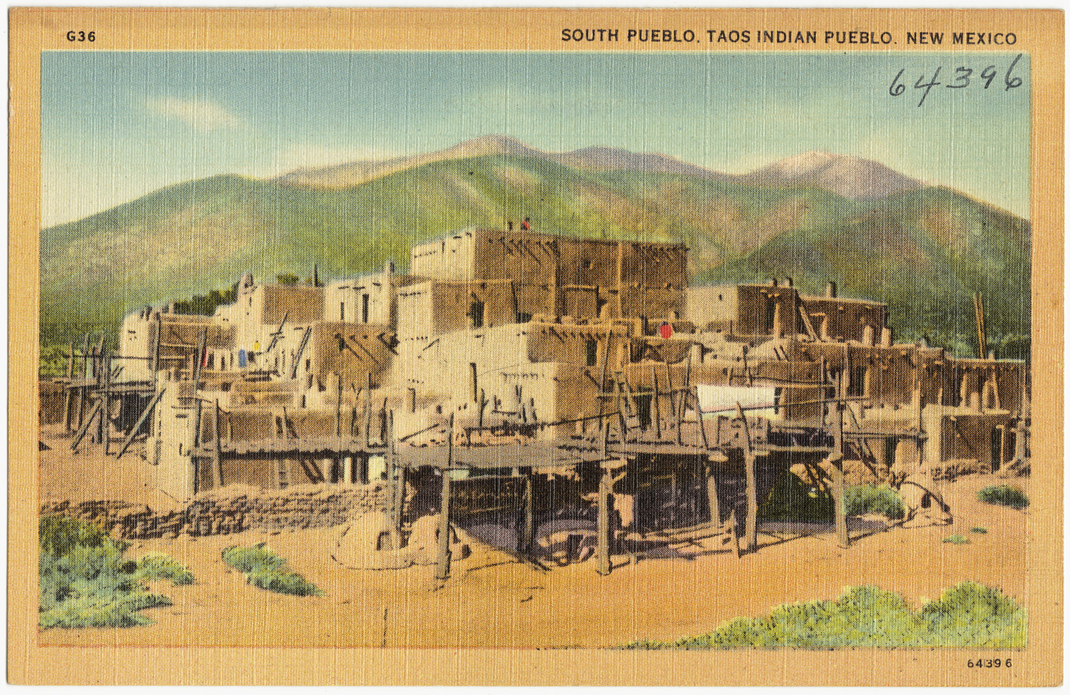 Vintage postcard of Taos Pueblo, New Mexico, showcasing multi-story adobe structures set against a backdrop of mountains, reflecting the region’s rich Native American heritage.