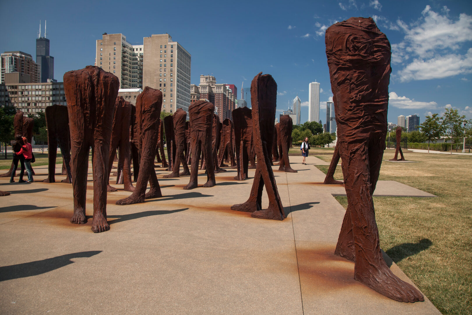 Agora, a large-scale outdoor sculpture by Magdalena Abakanowicz in Grant Park, Chicago, featuring a collection of towering, headless cast iron figures symbolizing themes of anonymity, collective identity, and movement.