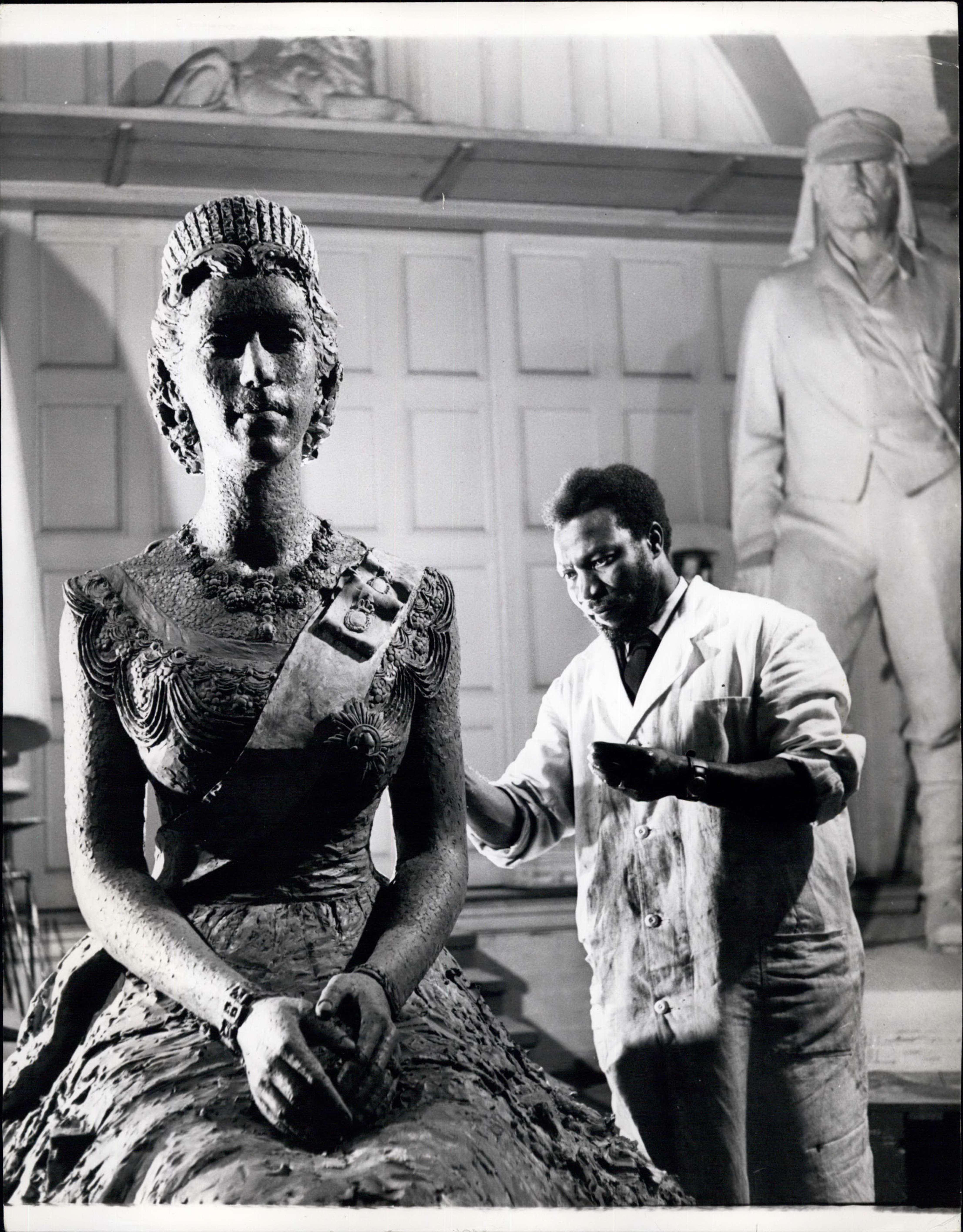 Ben Enwonwu sculpting the portrait of Queen Elizabeth II in his studio, 1956 — the first royal commission awarded to an African artist. | Aurora & Athena Auction House Ben Enwonwu sculpting the portrait of Queen Elizabeth II in his studio, 1956 — the first royal commission awarded to an African artist.