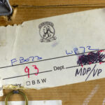 Archival label on the back of "Two Figures with Flags" with reference numbers.