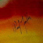 Close-up of Paul Jenkins' signature on his watercolor artwork "Flowing Spectrum", signed in black ink over red and orange wash.