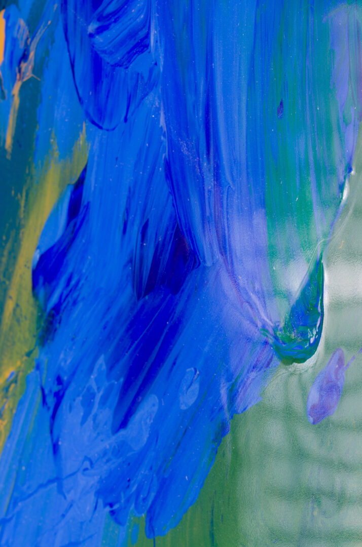 Close-up detail of the abstract brushstrokes in blue and green